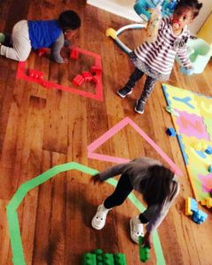 Kids playing with puzzles and blocks.