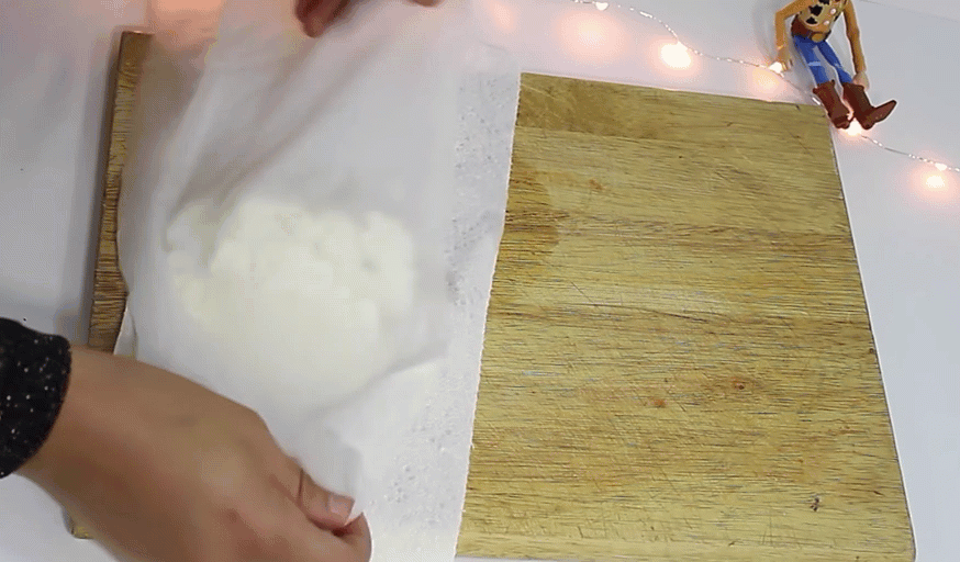 a woman pats a dough dry to make plastic from milk